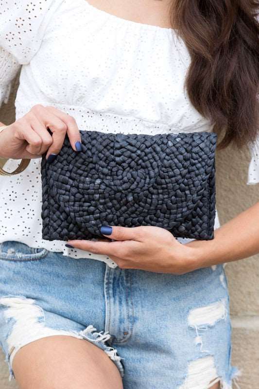 Fashionable and trendy fold over straw clutch bag with a chic design